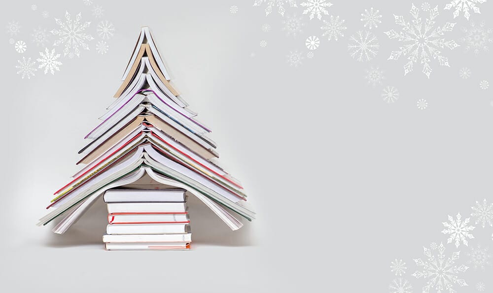 symbol Christmas tree from a colorful books on grey background. Empty copy space for your greetings write academy awards winner competition writing contest prize win free